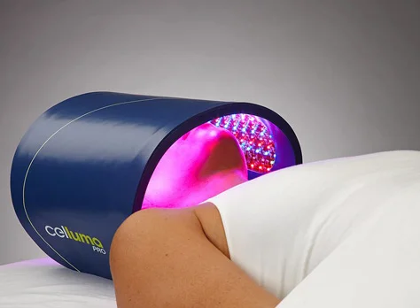 An LED light therapy panel positioned over the face.