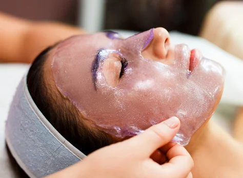 A Hydrojelly mask being lifted from the face.